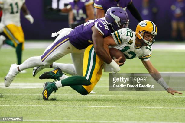 Aaron Rodgers of the Green Bay Packers is tackled by D.J. Wonnum of the Minnesota Vikings during the fourth quarter at U.S. Bank Stadium on September...