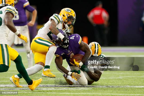 Dalvin Cook of the Minnesota Vikings is tackled by De'Vondre Campbell and Jaire Alexander of the Green Bay Packers during the fourth quarter of the...
