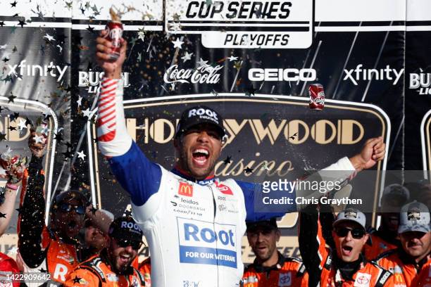 Bubba Wallace, driver of the ROOT Insurance Toyota, celebrates in victory lane after winning the NASCAR Cup Series Hollywood Casino 400 at Kansas...
