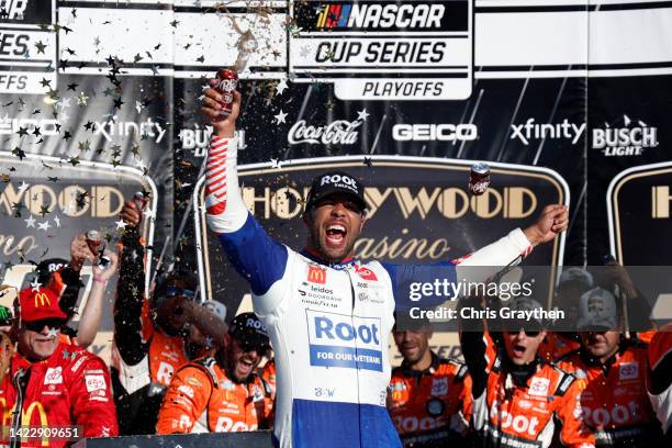Bubba Wallace, driver of the ROOT Insurance Toyota, celebrates in victory lane after winning the NASCAR Cup Series Hollywood Casino 400 at Kansas...
