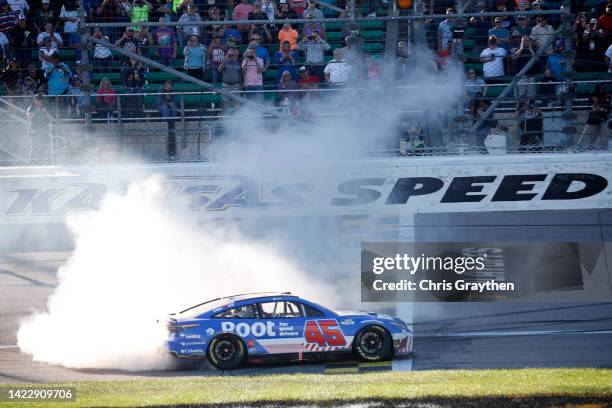 Bubba Wallace, driver of the ROOT Insurance Toyota, celebrates with a burnout after winning the NASCAR Cup Series Hollywood Casino 400 at Kansas...