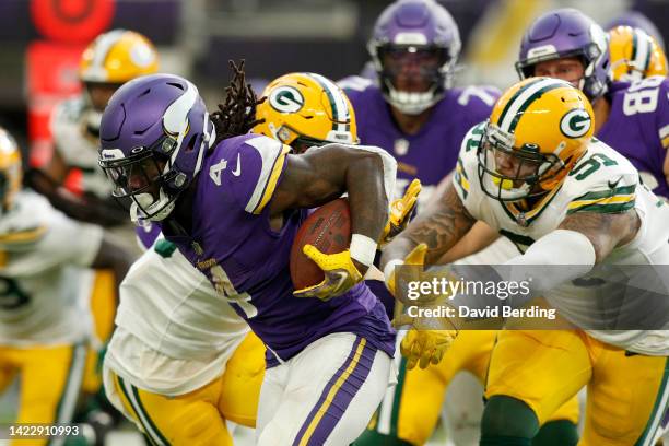 Dalvin Cook of the Minnesota Vikings runs past Krys Barnes of the Green Bay Packers during the fourth quarter at U.S. Bank Stadium on September 11,...