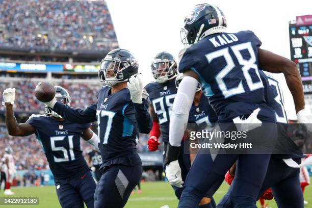 Safety Amani Hooker of the Tennessee Titans celebrates with teammates after intercepting a pass during the fourth quarter against the New York Giants...