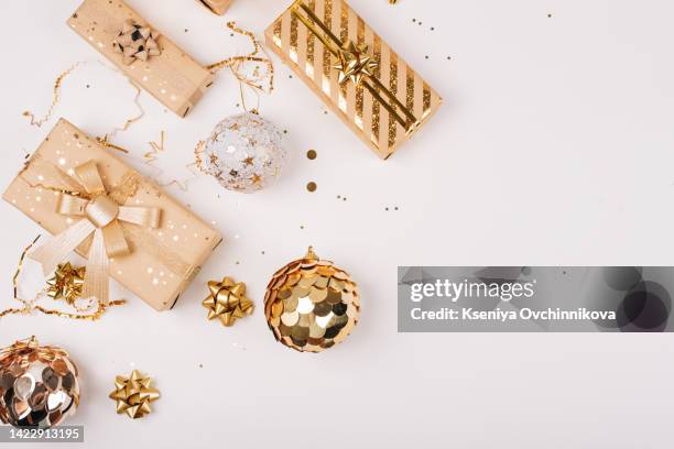 happy new year banner. christmas design gold gifts box, golden balls, glitter confetti stars on white background. decoration objects viewed from above. - celebration florida stock pictures, royalty-free photos & images
