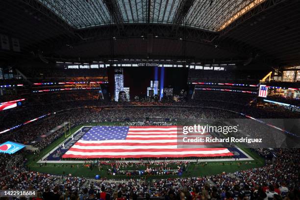 General view inside AT&T Stadium during the national anthem with an American Flag over the field before the game between the Tampa Bay Buccaneers and...