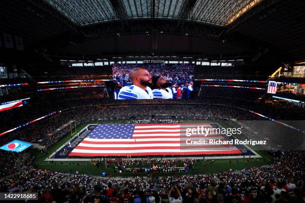 General view inside AT&T Stadium during the national anthem with an American Flag over the field before the game between the Tampa Bay Buccaneers and...