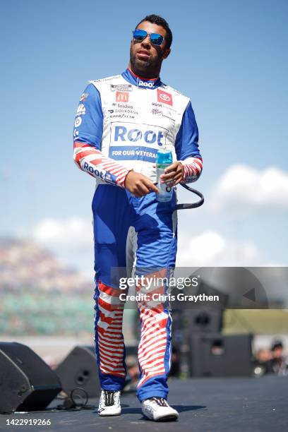 Bubba Wallace, driver of the ROOT Insurance Toyota, walks onstage during driver intros prior to the NASCAR Cup Series Hollywood Casino 400 at Kansas...