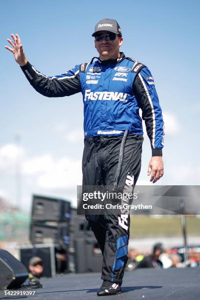 Chris Buescher, driver of the Fastenal Ford, walks onstage during driver intros prior to the NASCAR Cup Series Hollywood Casino 400 at Kansas...