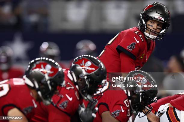 Tom Brady of the Tampa Bay Buccaneers looks on over the offensive line during the first half against the Dallas Cowboys at AT&T Stadium on September...