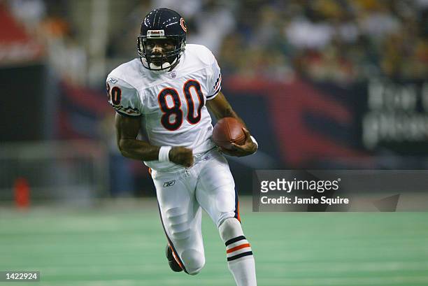 White receiver Dez White of the Chicago Bears carries the ball up the field during the game against the Atlanta Falcons on September 15, 2002 at the...