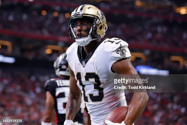 Michael Thomas of the New Orleans Saints reacts after catching a touchdown pass during the fourth quarter against the Atlanta Falcons at...