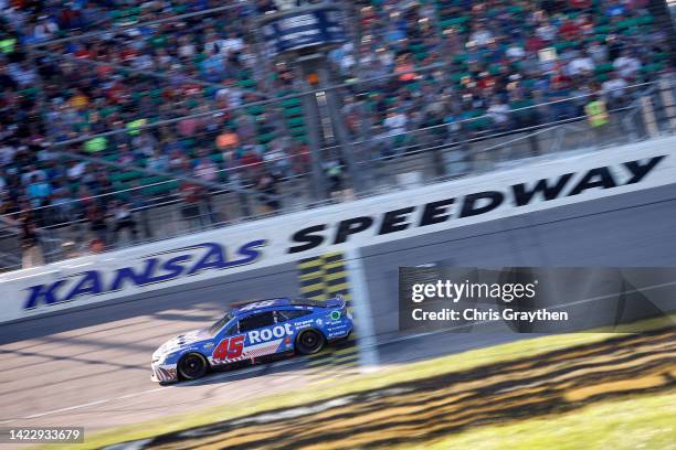 Bubba Wallace, driver of the ROOT Insurance Toyota, crosses the finish line to win the NASCAR Cup Series Hollywood Casino 400 at Kansas Speedway on...