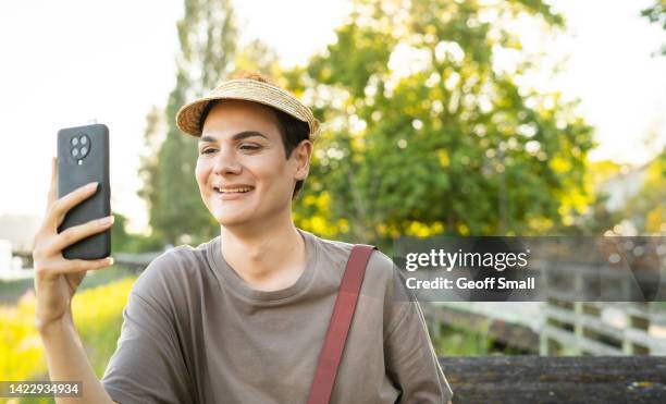 a person taking a selfie on a boardwalk - non binary stereotypes stock pictures, royalty-free photos & images