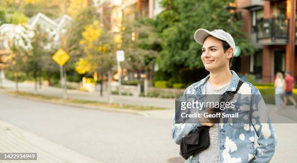 smiling person in the city - non binary stereotypes stock pictures, royalty-free photos & images