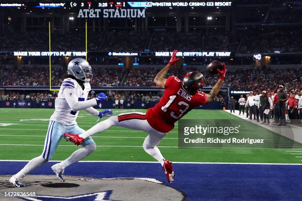 Mike Evans of the Tampa Bay Buccaneers scores a touchdown ahead of Trevon Diggs of the Dallas Cowboys during the second half at AT&T Stadium on...