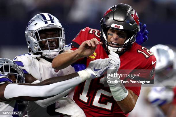 Donovan Wilson of the Dallas Cowboys and Tarell Basham tackle Tom Brady of the Tampa Bay Buccaneers during the second half at AT&T Stadium on...
