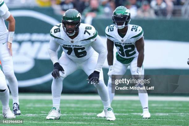 George Fant and Michael Carter of the New York Jets in action against the Baltimore Ravens at MetLife Stadium on September 11, 2022 in East...