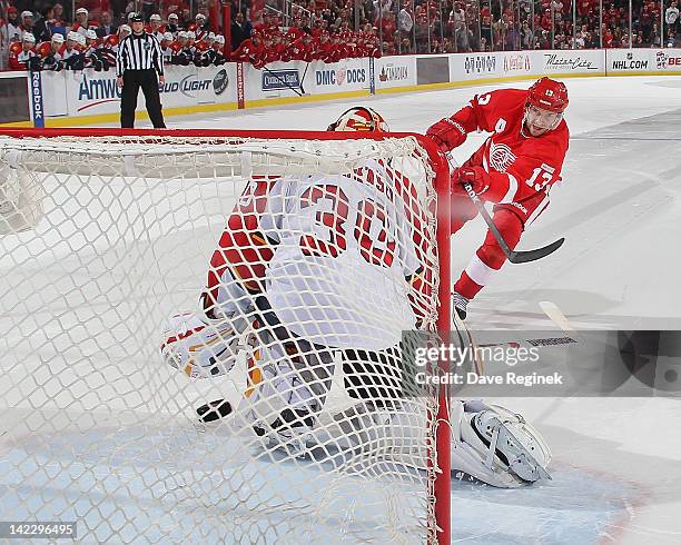 Pavel Datsyuk of the Detroit Red Wings scores a goal on Scott Clemmensen of the Florida Panthers in a shootout during an NHL game at Joe Louis Arena...