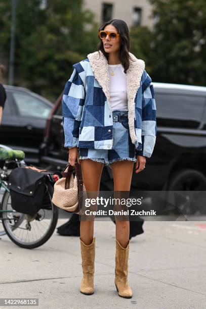 Babba Rivera is seen wearing a blue quilted jacket and skirt and brown cowboy boots outside the Ulla Johnson show during New York Fashion Week S/S...