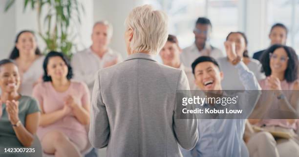 wow, motivation and celebration with a crowd or audience cheering for a leader, manager or ceo in a meeting at work. training, coaching and success with a woman boss talking to staff in a conference - senior people training imagens e fotografias de stock