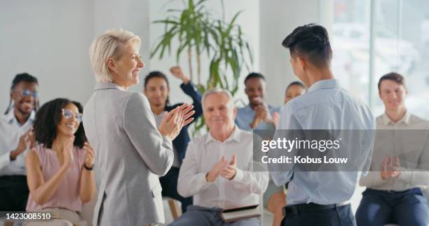 motivation, training and clapping employee celebration, cheering and excited at presentation or speech. diverse crowd applause and share positive energy at business integration, support at conference - senior orientation announcement stock pictures, royalty-free photos & images