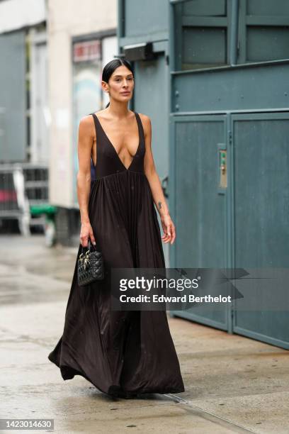 Guest wears a dark brown V-neck / tank-top long dress, a black shiny leather Lady D-Lite hand bag from Dior, black shiny varnished leather platform...