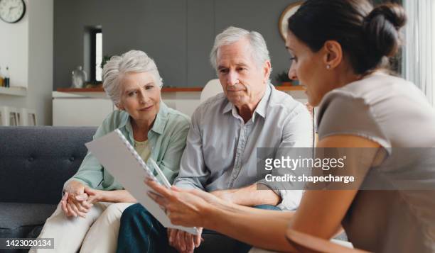 financial advisor, senior couple and finance paper with savings budget, investment growth and retirement loan. healthcare insurance, medical security and tax planning for elderly in home living room - erfenis stockfoto's en -beelden