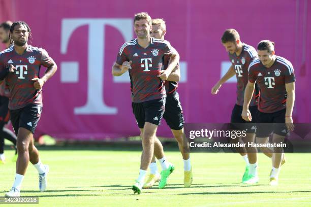 Thomas Müller of FC Bayern München smiles during a training session at Saebener Strasse training ground ahead of their UEFA Champions League group C...