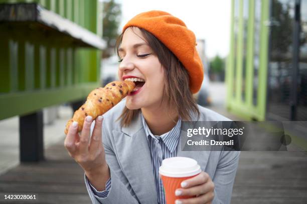 woman bite croissant outdoor bar breakfast - croissant jam stock pictures, royalty-free photos & images