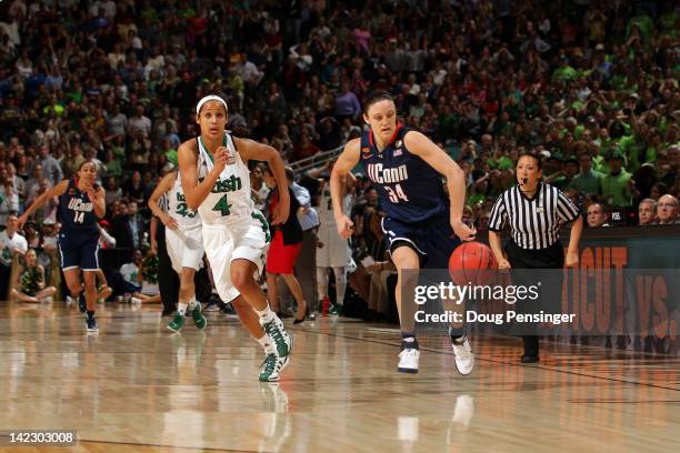 Kelly Faris of the Connecticut Huskies steals the ball from Skylar Diggins of the Notre Dame Fighting Irish with less then 20 seconds to go in the...