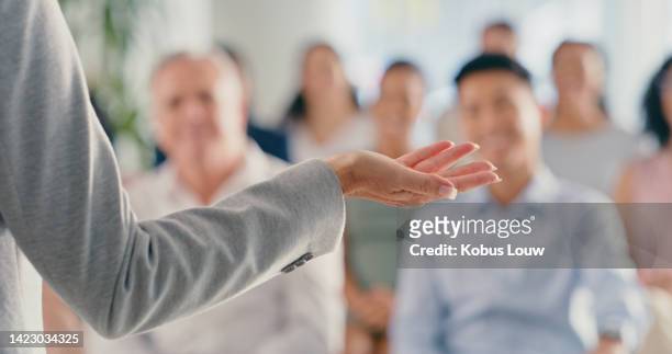 hand of a leader, ceo and boss in a seminar, training or coaching meeting at work. motivational female speaker talking at a leadership conference or workshop in front of an audience or crowd - senior orientation announcement stock pictures, royalty-free photos & images
