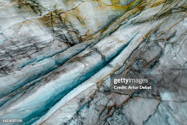 close view with drone of the svinafellsjokull glacier with dramatic stripes in iceland. - frozen ground stock pictures, royalty-free photos & images