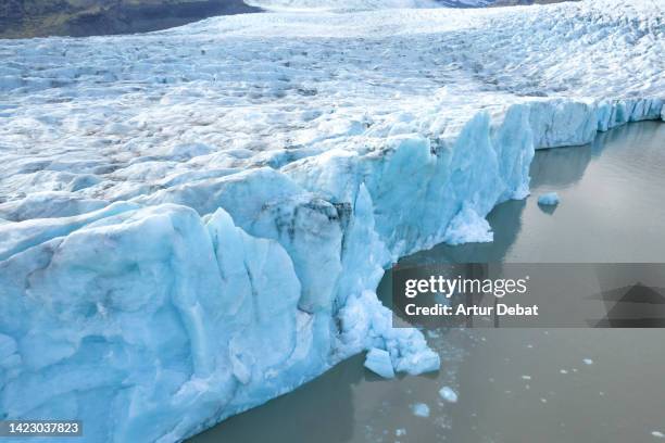 aerial view flying above of the glacier edge breaking in iceland. - glacier collapsing stock pictures, royalty-free photos & images