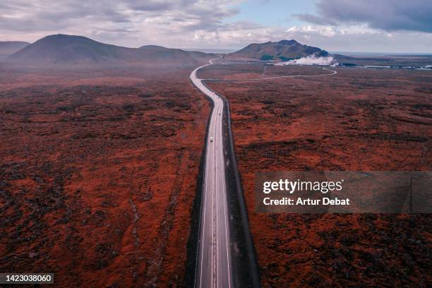 drone view of straight road with the lava landscape plain in iceland. - travel boundless stock pictures, royalty-free photos & images