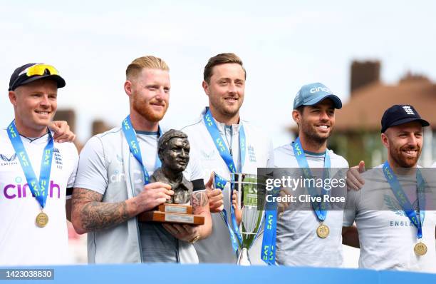 England captain Ben Stokes Ollie Robinson and his team celebrate behind the winners board after their 2-1 series victory after day five of the Third...