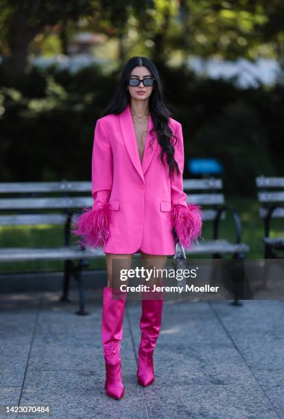 Fashion week guest is seen wearing a pink look with prada shades, bag and naked wolfe shoes outside the Bronx and Banco Show during New York Fashion...