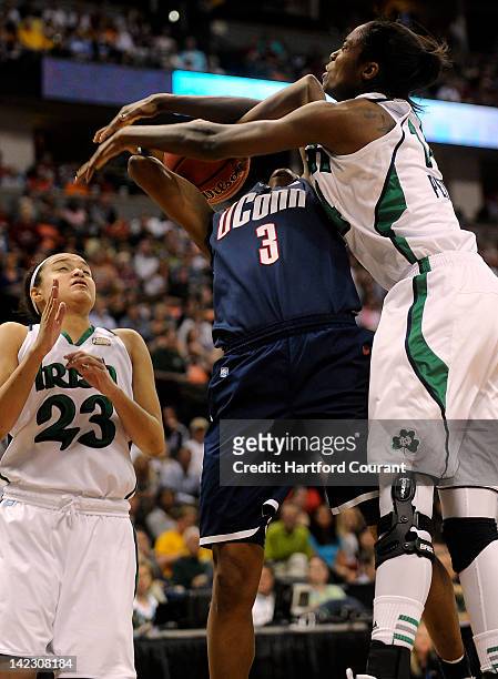 Tiffany Hayes of Connecticut looked for a foul as she drives to the hoop against Devereaux Peters of Notre Dame during the second half of the...
