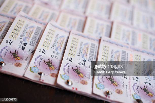 close up of thai lottery tickets on street stall - loterij stockfoto's en -beelden