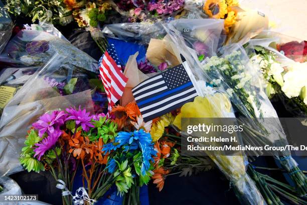 Flowers have been left on top of the police cruiser belonging to fallen Arvada police officer Dillon Michael Vakoff outside of the Arvada Police...