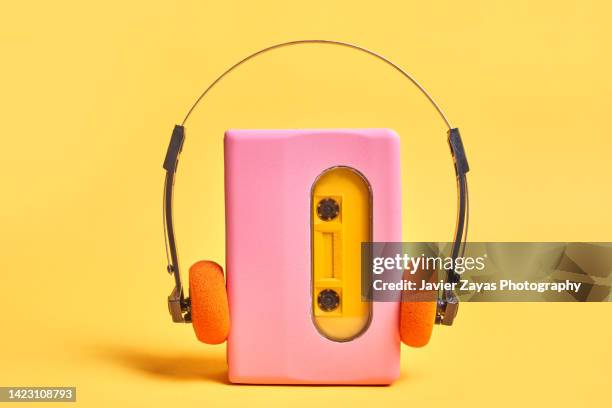 pink portable audio cassette player on yellow - música pop fotografías e imágenes de stock