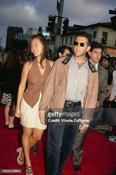 Actress Tia Carrere and producer Elie Samaha attend the 'In the Line of Fire' Westwood Premiere at Mann Village Theatre in Westwood, California,...
