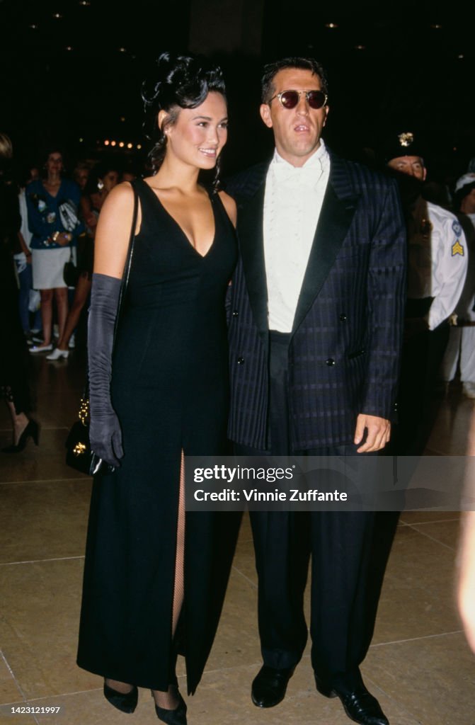 Samaha Signs Tia Carrere with her partner Elie Samaha, circa 1992. News Photo ...