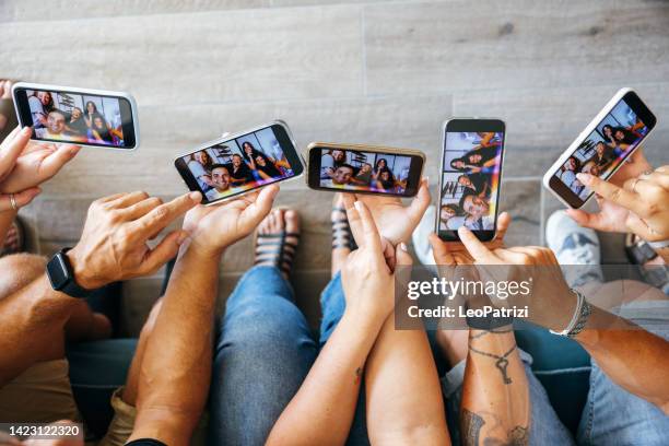 friends on their mobiles looking at their selfie - american influencer stock pictures, royalty-free photos & images