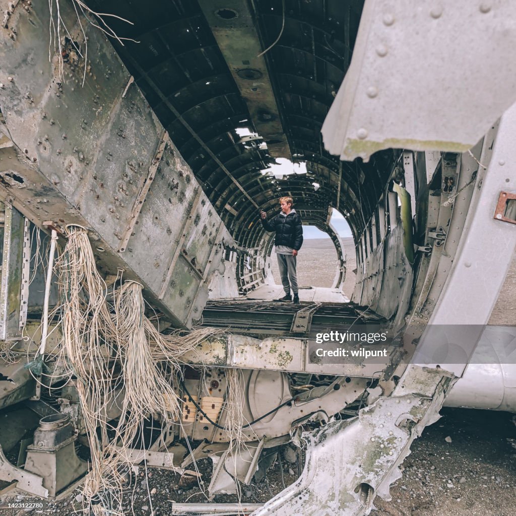 Young teenage male inside the wrecked DC-3 Plane on Sólheimasandur