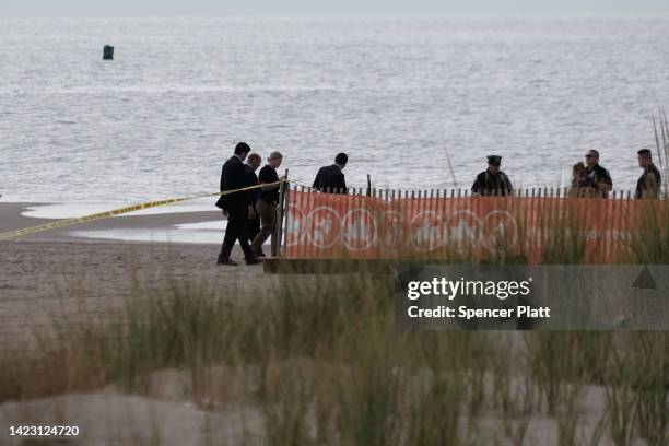 Police work along a stretch of beach at Coney Island which is now a crime scene after a mother is suspected of drowning her children in the ocean on...