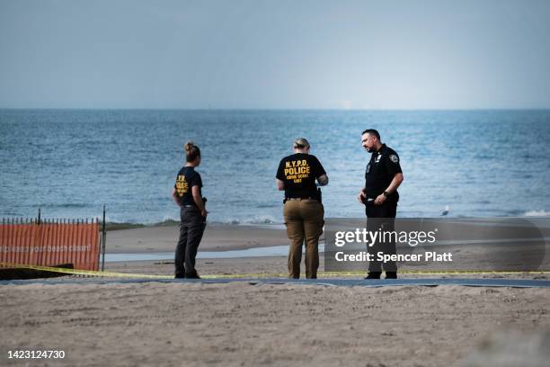 Police work along a stretch of beach at Coney Island which is now a crime scene after a mother is suspected of drowning her children in the ocean on...