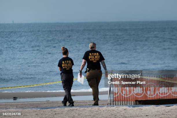 Police work along a stretch of beach at Coney Island which is now a crime scene after a mother is suspected of drowning her children in the ocean on...