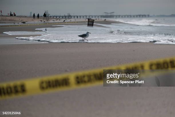 Police tape closes a stretch of beach at Coney Island which is now a crime scene after a mother is suspected of drowning her children in the ocean on...