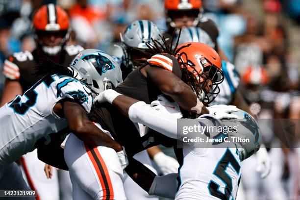 Linebacker Cory Littleton and defensive end Brian Burns of the Carolina Panthers tackle running back Kareem Hunt of the Cleveland Browns during the...