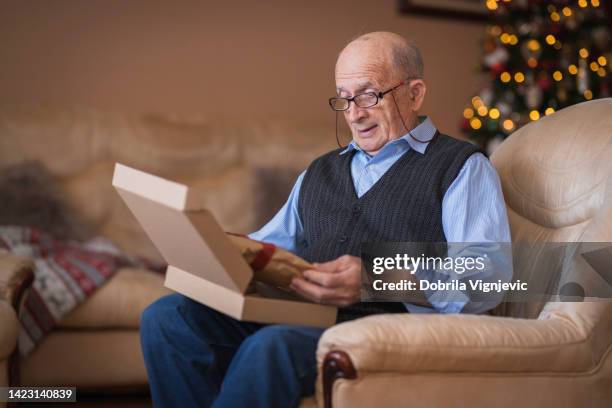 surprised senior man opening a delivered package - elderly receiving paperwork stock pictures, royalty-free photos & images
